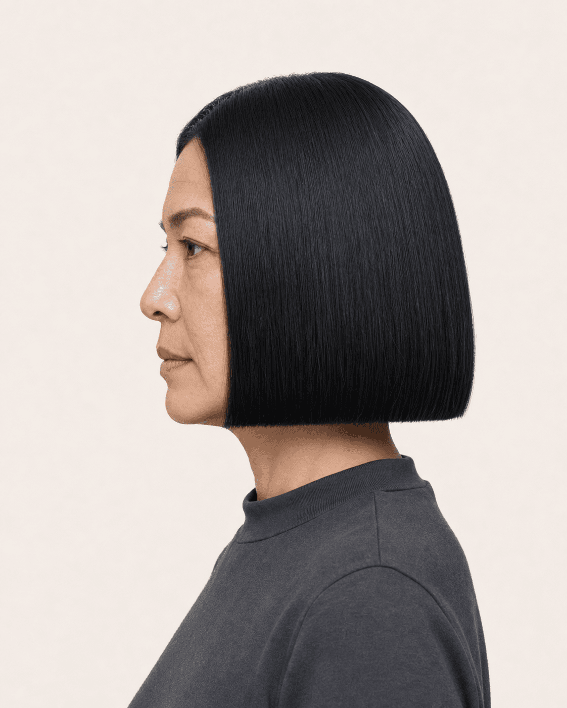 Side profile of a blunt chin-length bob showing level baseline and minimal bevel