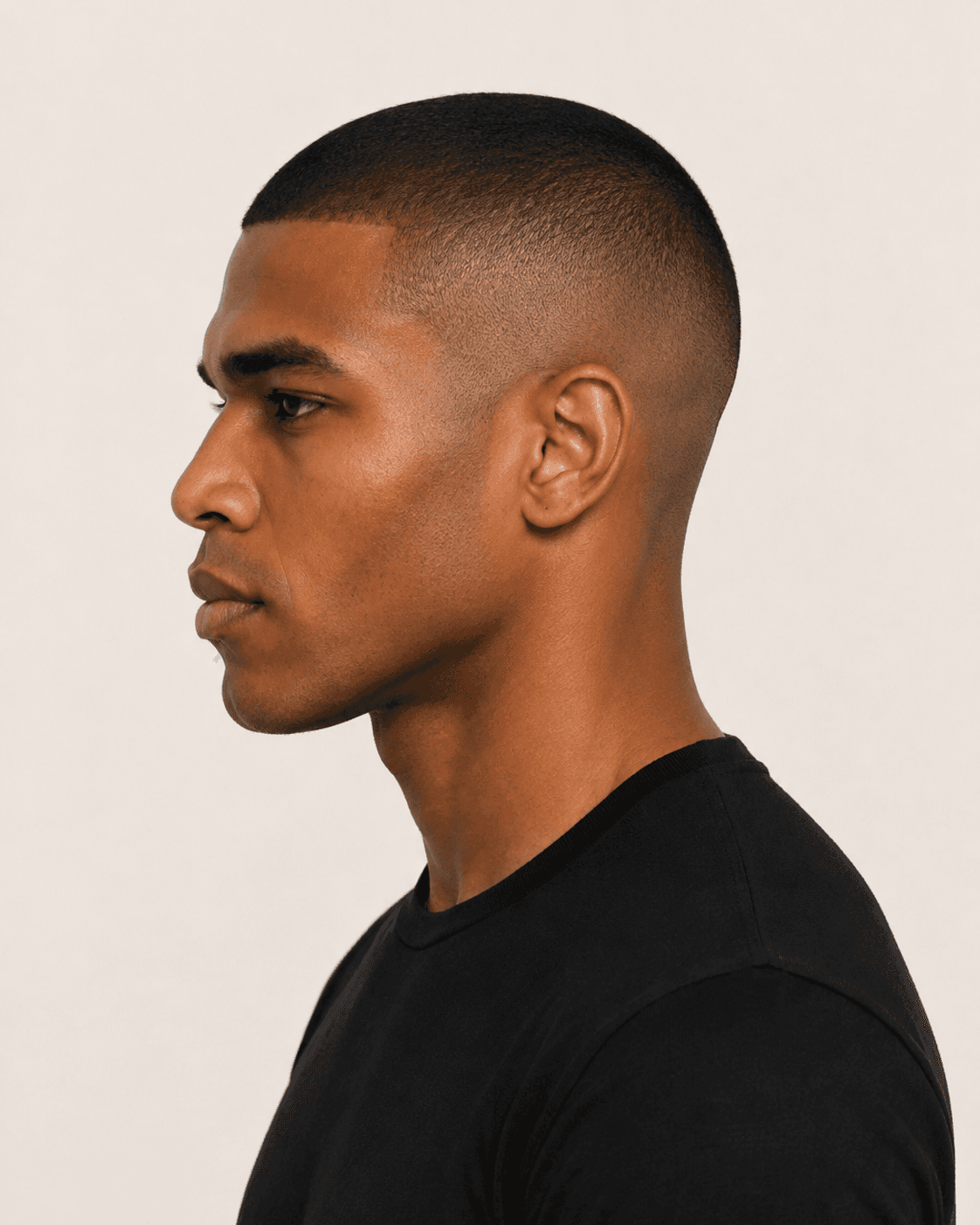 Side profile of a buzz cut with subtle fade at the temple