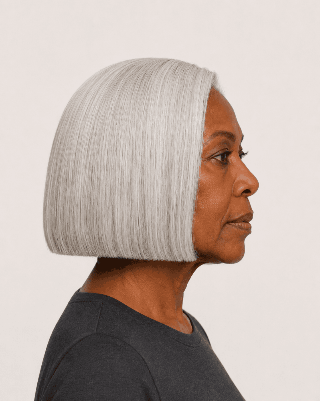 Side profile of a classic silver bob showing the level blunt baseline and smooth crown
