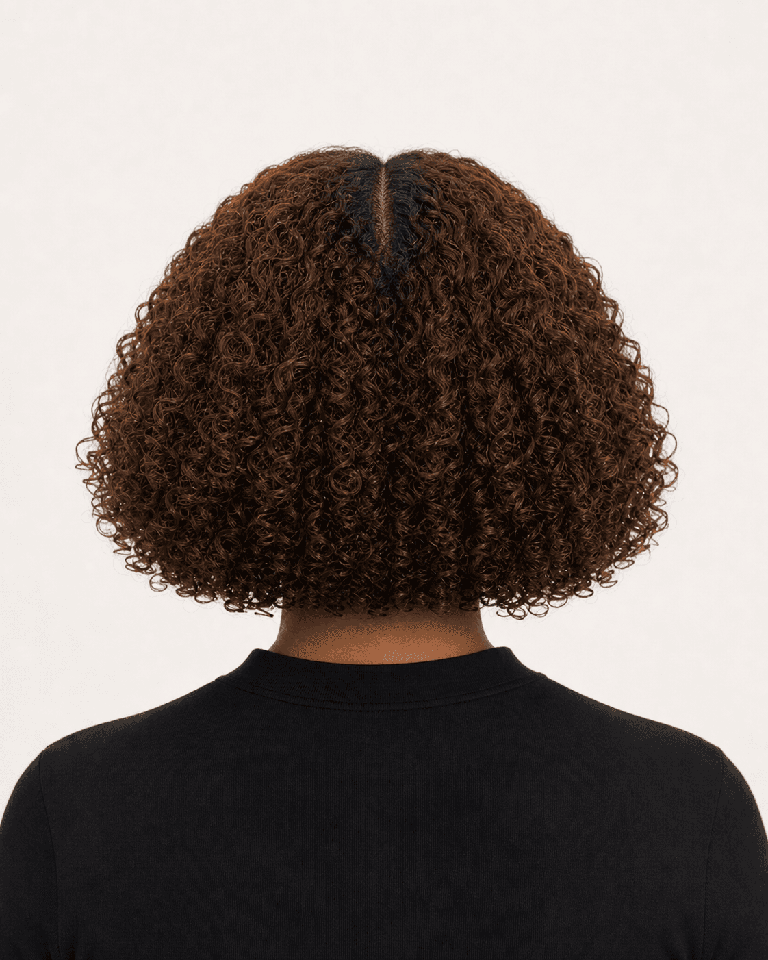 Rear view of a rounded 3B curly bob showing center part, volume, and balanced perimeter