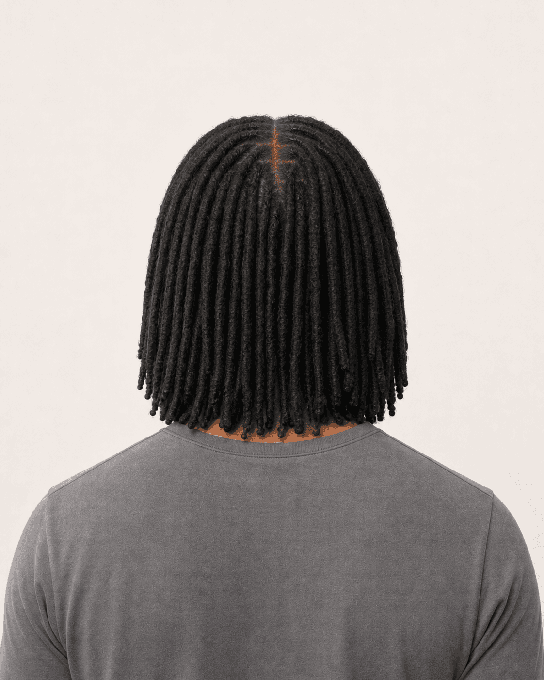 Rear view of shoulder-length locs showing organic sections and a naturally varied perimeter
